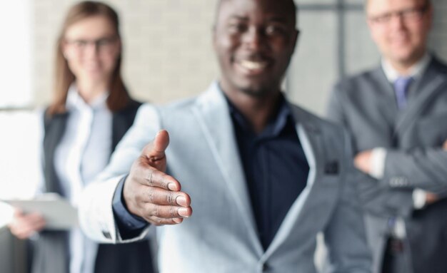 Photo portrait of an african american business man with an open hand ready to seal a deal