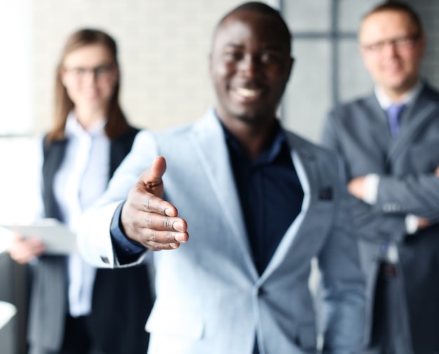 Portrait of an African American business man with an open hand ready to seal a deal