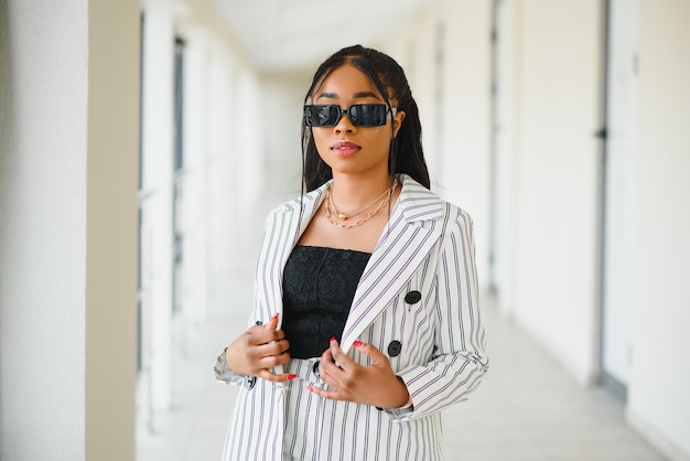 Portrait of African American businesswoman standing inside office building