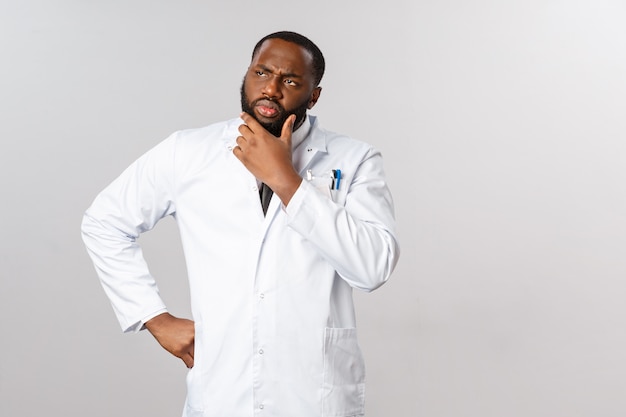 Portrait African American doctor in white uniform.