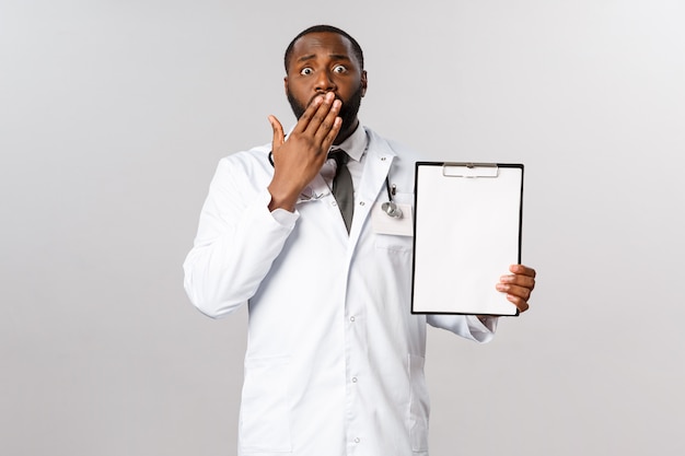 Portrait African American Doctor in white uniform.