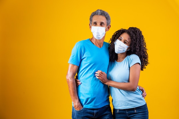 Portrait of african american father with daughter wearing mask. father and daughter wearing mask to protect covid 19, quarantine. stay at home concept. father's day!