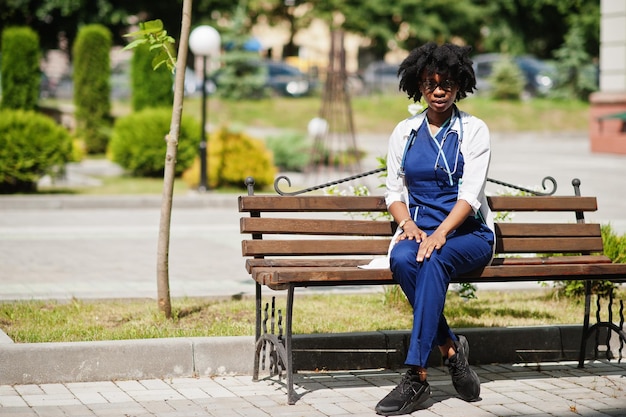 Portrait of African American female doctor with stethoscope wearing lab coat.