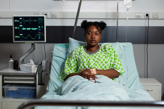 Portrait of african american girl sitting in hospital ward