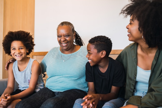 Portrait of African American grandmother, mother and children spending good time together at home. Family and lifestyle concept.