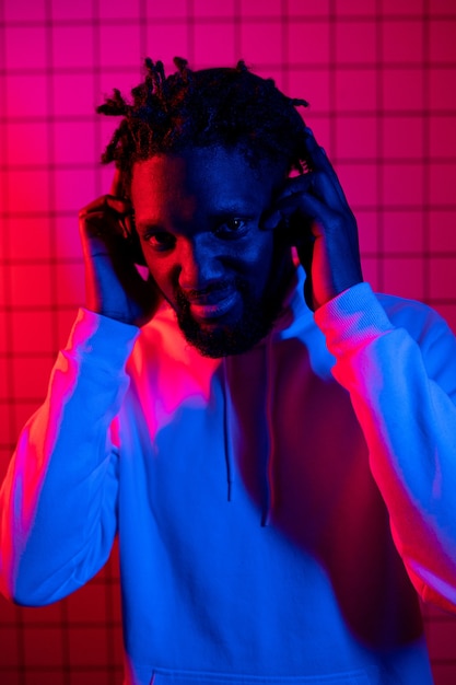 Portrait of an african american man in a hoodie on a neon background redblue background high quality photo