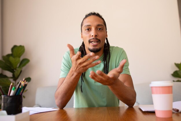 Photo portrait of african american man talking while looking at the camera at home. people and emotions concept