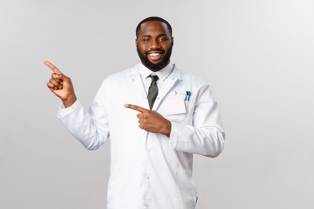 Portrait of African American physician or doctor in white uniform.