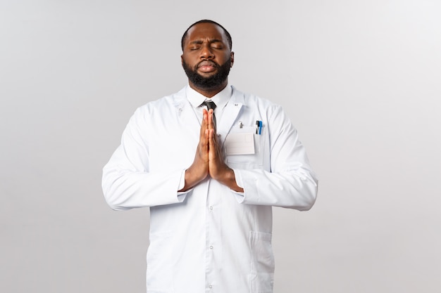 Portrait of African American physician or doctor in white uniform.