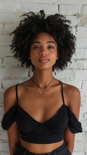 Portrait of African attractive woman against background of white brick wall