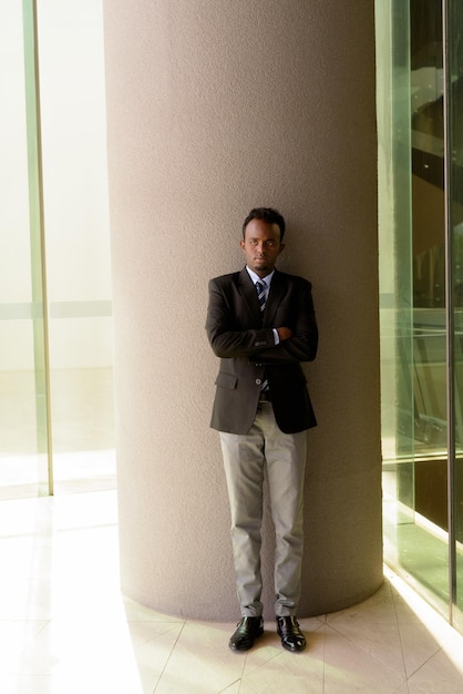 Portrait of African businessman wearing suit and tie outdoors in city