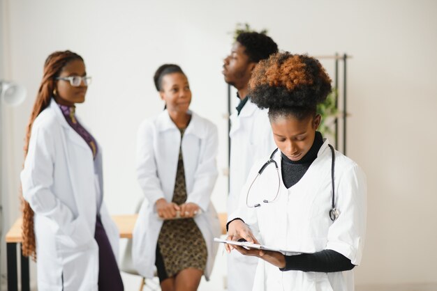 Portrait of a african doctor in front of his medical team