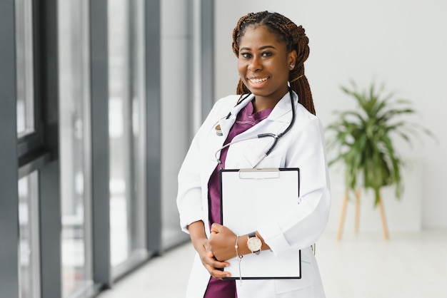 Portrait of african female doctor at workplace