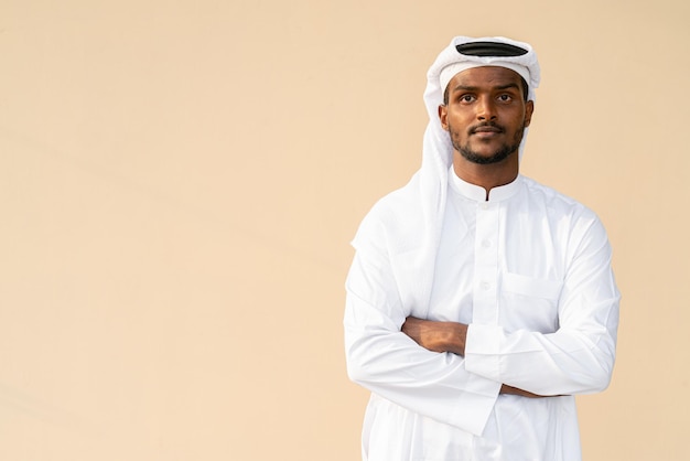 Portrait of African Muslim man wearing religious clothing an scarf with arms crossed