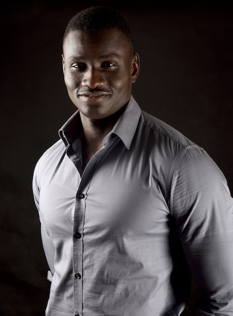 Photo portrait of an african young man on black