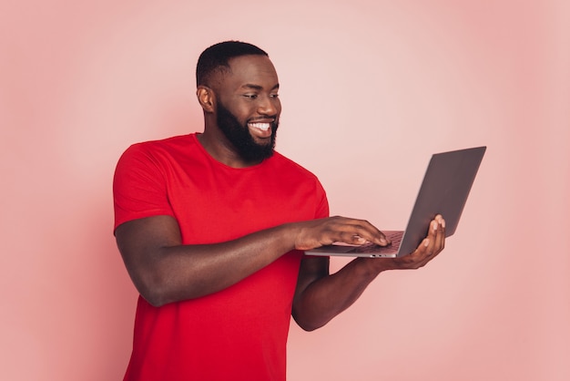 Portrait of afro american man using laptop typing