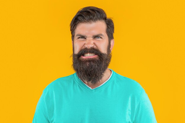 Portrait of aggressive bearded man portrait of bearded man isolated on yellow