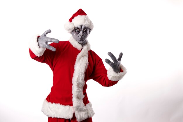 portrait of alien in Santa Claus costume on white background