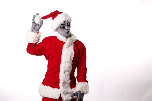 portrait of alien in Santa Claus costume on white background