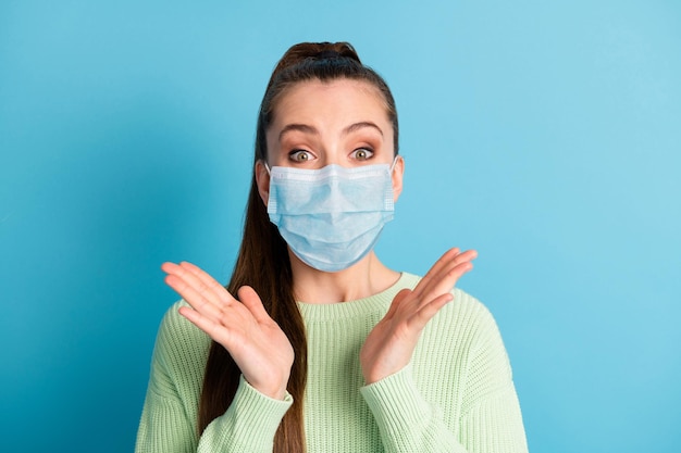 Portrait of amazed delighted girl reaction wear medical respirator isolated over bright vivid blue color background