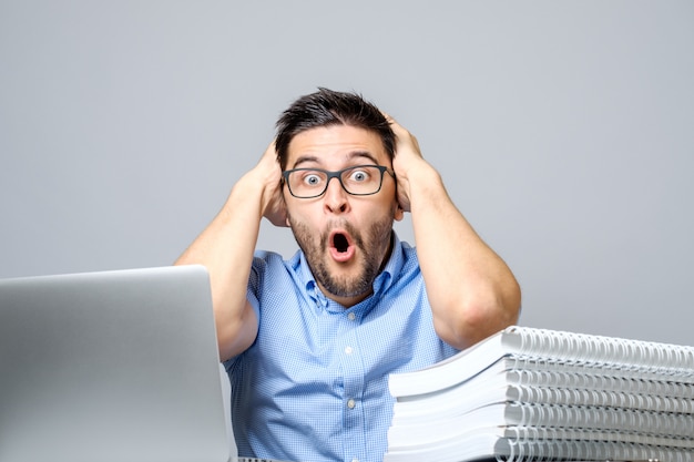 Portrait of amazed man with laptop computer