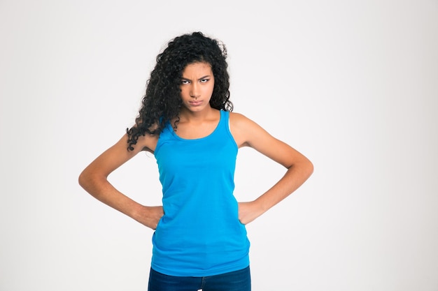 Portrait of angry afro american woman standing isolated