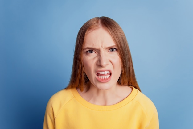 Portrait of angry aggressive lady crazy face quarrel concept on blue background