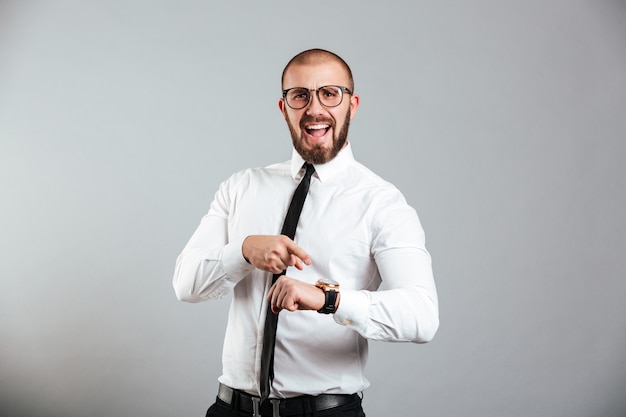 Portrait of an angry businessman pointing