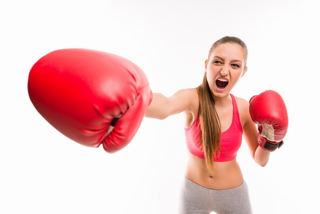 A portrait of angry girl in boxing gloves