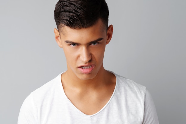 Portrait of angry irritated young man teenager 