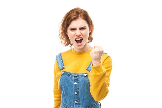 Photo portrait angry redhead young woman screaming isolated on white studio background showing negative emotionsxa