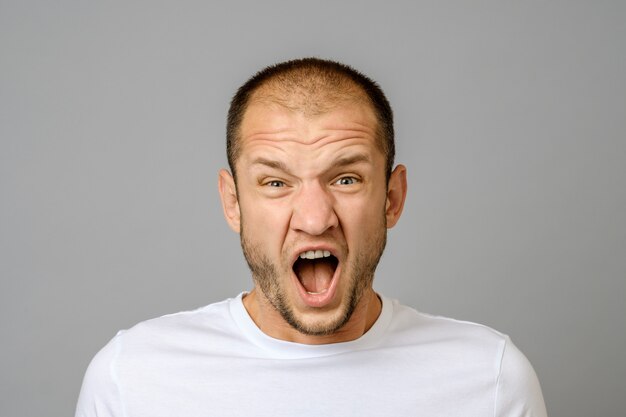 Portrait of angry screaming young man