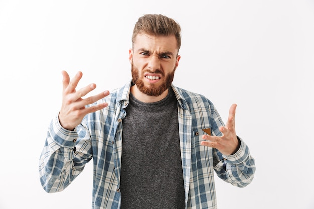 Photo portrait of an angry young bearded man standing