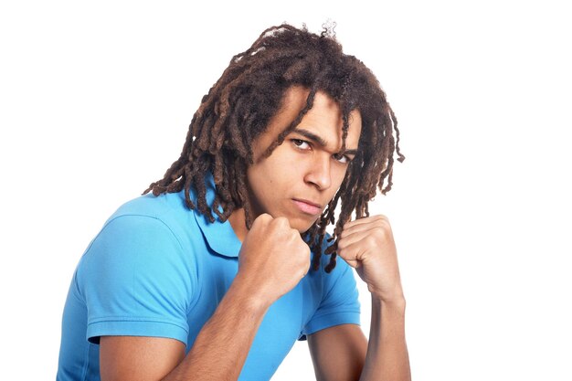 Portrait of angry young man against white background