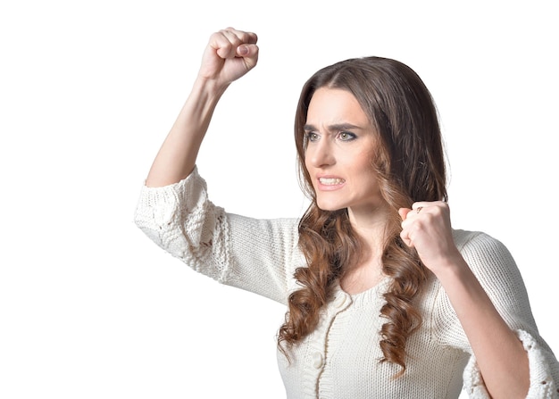 Portrait of angry young woman on white