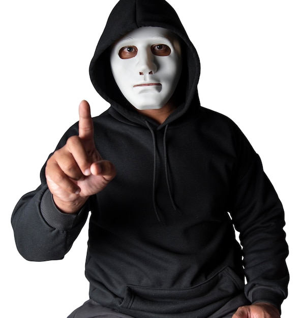 A portrait of an anonymous hacker wearing a mask and a black hoodie sitting with his head tilted and terrifying with clipping path Hacking and malware concept