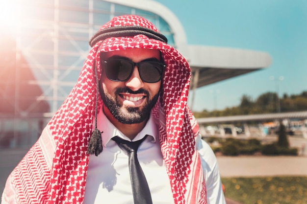 Portrait of arab man wears sunglasses and keffiyeh at the airport
