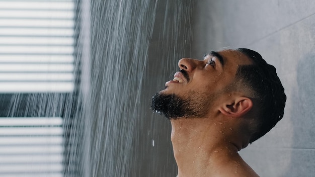 Portrait Arab Spaniard Indian young handsome manly wet man bearded brunette guy washes in shower