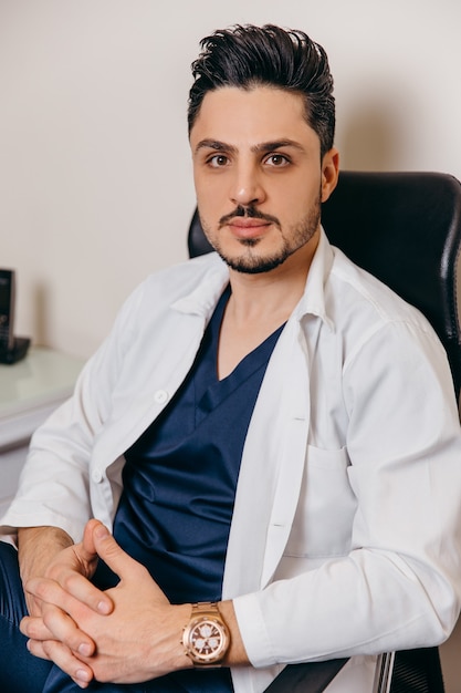 Portrait of an Arab or Turkish young doctor in a white coat