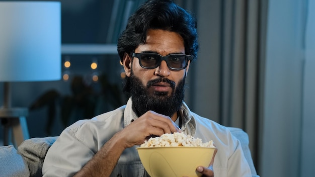 Portrait arabic hispanic latino indian muslim bearded man in 3d glasses watching TV relaxed guy