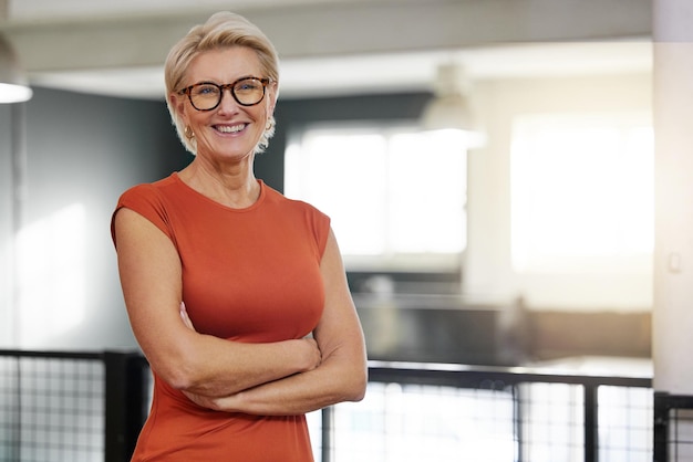Portrait arms crossed and smile of business woman in office with pride for career and job Ceo glasses boss face and happy confident and proud elderly female entrepreneur from Canada in company