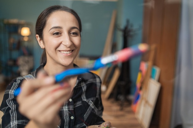 Portrait of artist conducting a painting workshop on brush stroke on canvas hand movements with brus