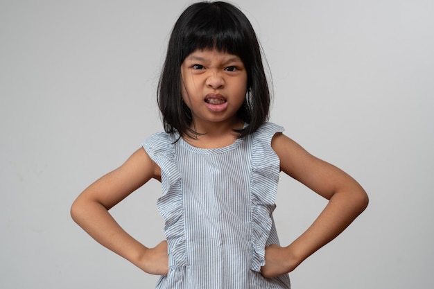 Portrait of Asian angry and sad little girl on white isolated background The emotion of a child