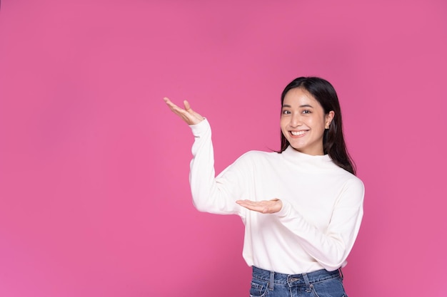 Portrait Asian beautiful happy young woman smiling cheerful and looking at camera isolated on pink studio background