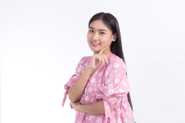 Portrait Asian beautiful woman in pink dress and black long hair Her hands touch cheek smile