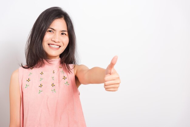 Portrait asian beautiful young woman standing she made finger thumbs up