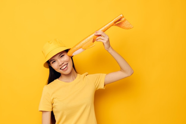 Portrait Asian beautiful young woman with a yellow plane in his hands a toy Monochrome shot