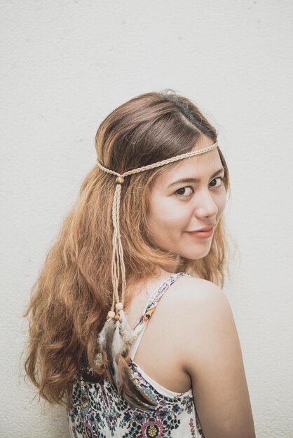 Photo portrait of asian bohemian girl on white wall vintage style