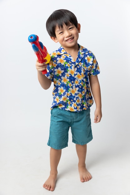 Portrait of Asian boy smiled with water gun