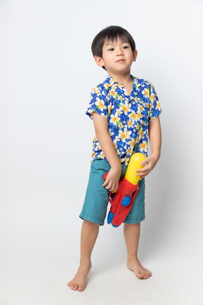 Portrait of Asian boy smiled with water gun